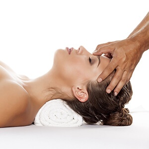 A lady receiving a head massage
